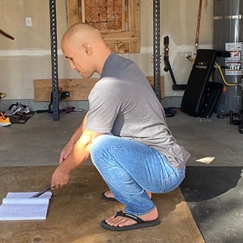 Jarlo in full squat while wearing jeans.