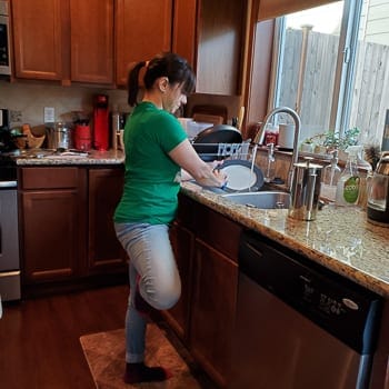 washing dishes standing on one leg
